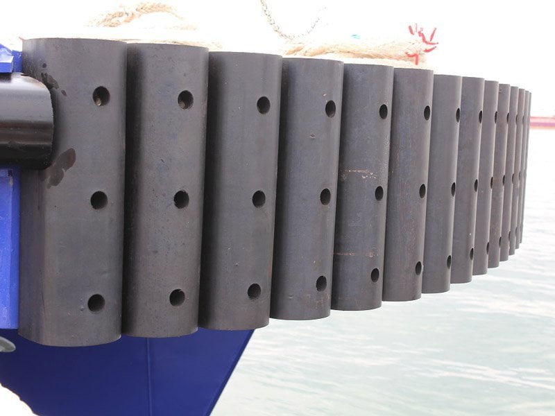 Continuous DD extruded rubber fenders bolted along the side of a commercial workboat