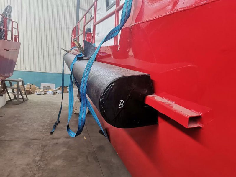 Solid foam collar section positioned against a workboat hull during installation.