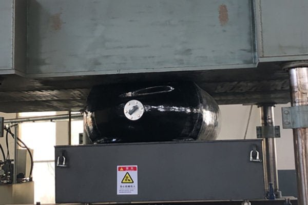 Compression testing machine verifying fender energy absorption
