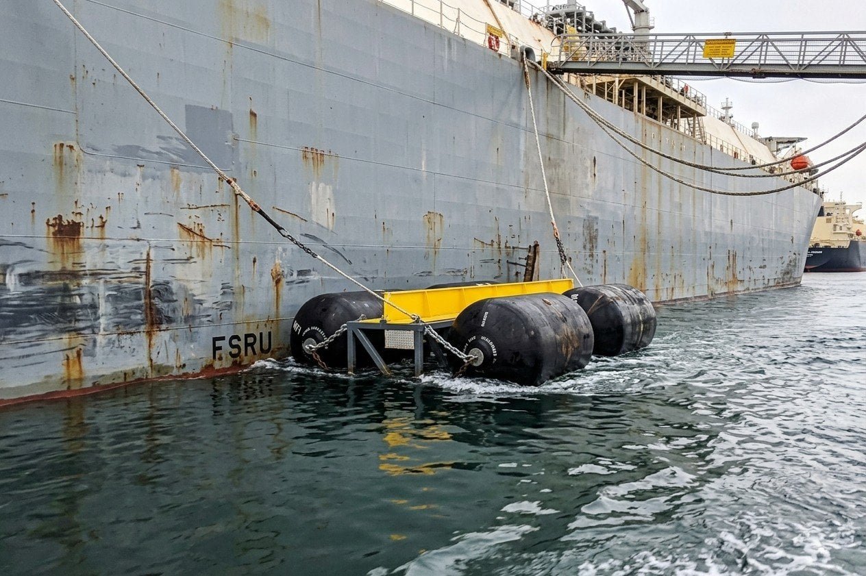Pneumatic fenders positioned along FSRU hull during LNG carrier berthing operation — SIGTTO fender requirements