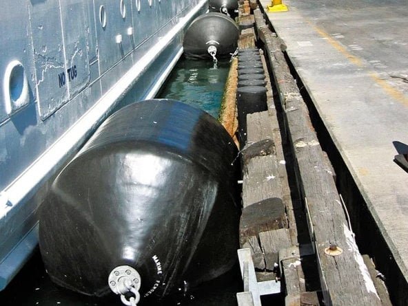 Foam-filled fender with black polyurea skin in service during a ship-to-ship lightering deployment
