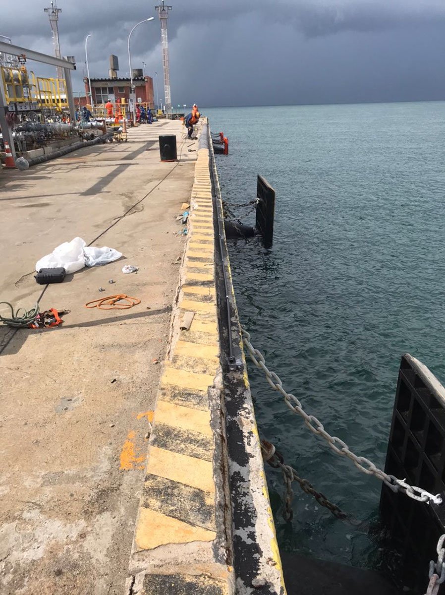 Installed cone fender and frontal panel at a quay waterline