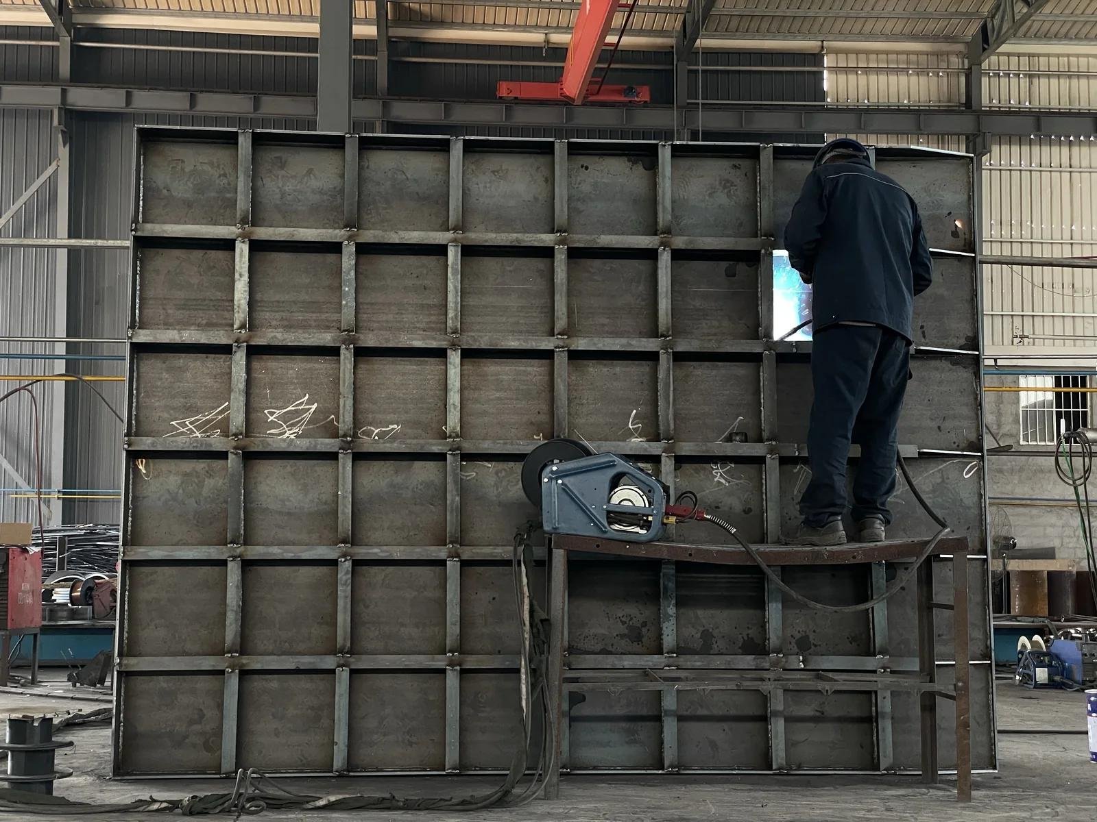 Welder working on the stiffener structure of a steel fender panel