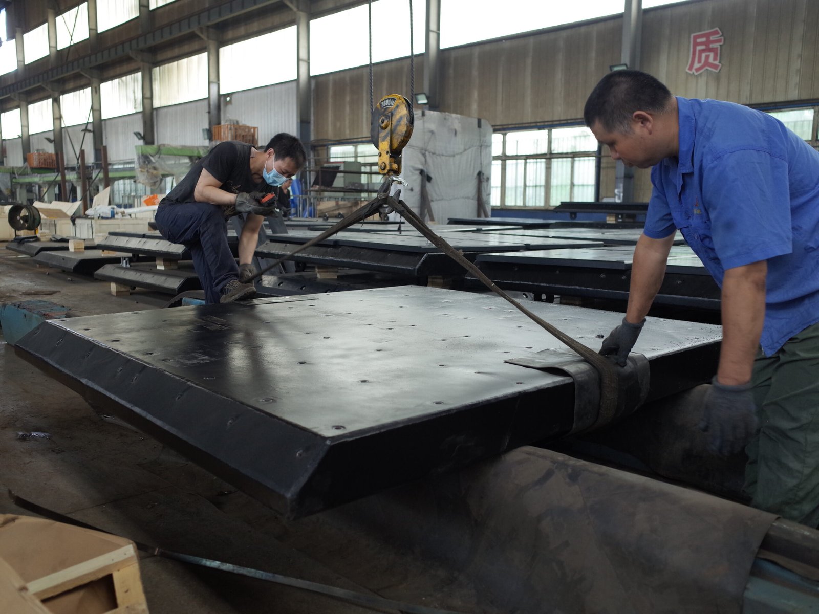Steel frontal panel being assembled in a workshop
