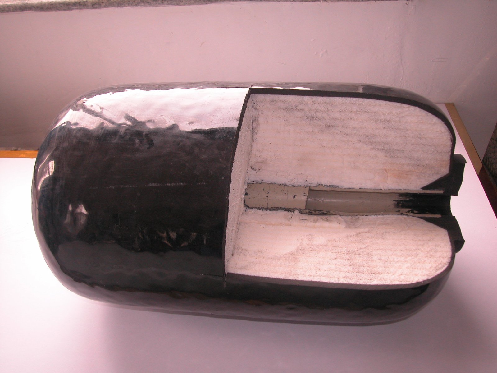Cutaway view of a foam-filled fender showing a white foam core inside a dark outer skin.