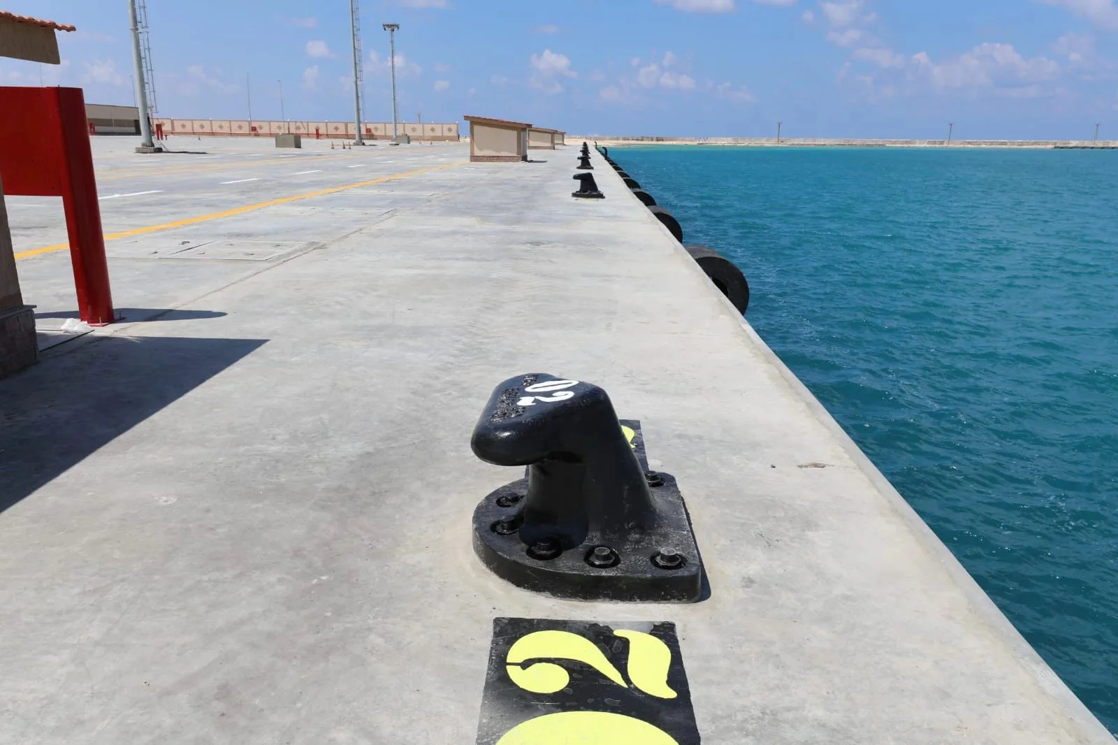 T-head mooring bollards installed along a commercial quay