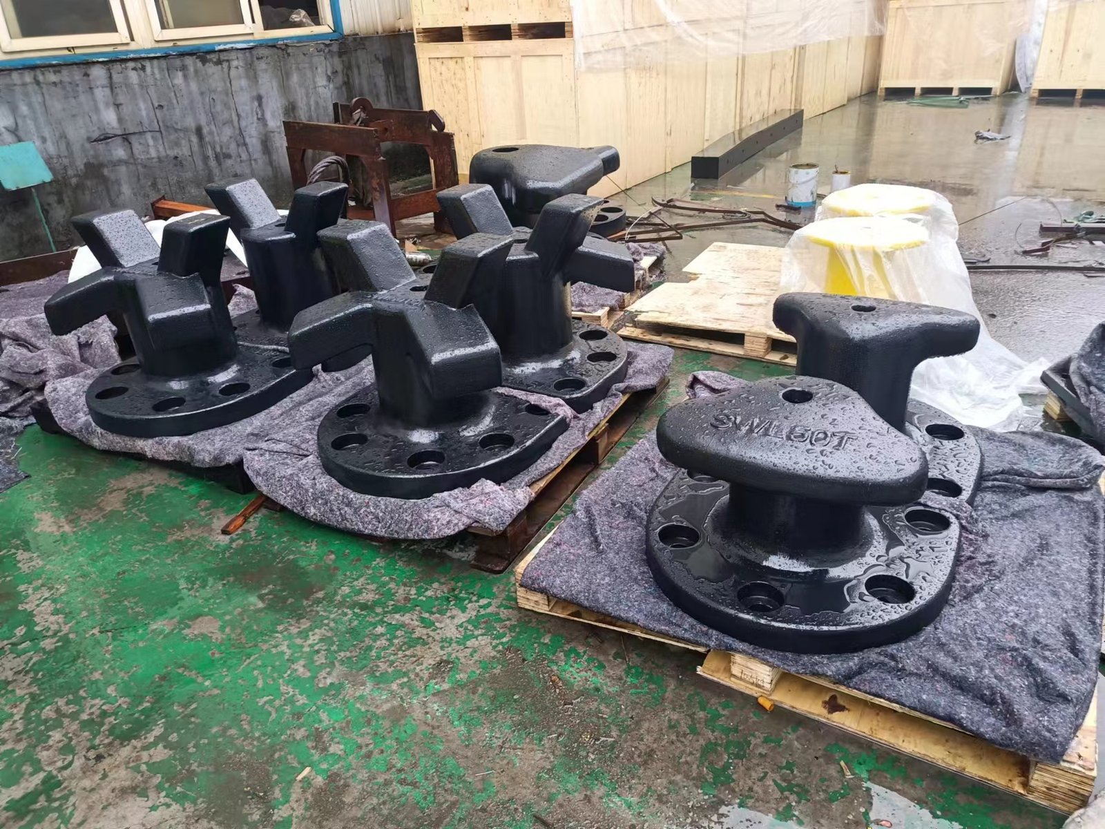 Black-coated 50 tonne T-head and staghorn mooring bollards at the workshop
