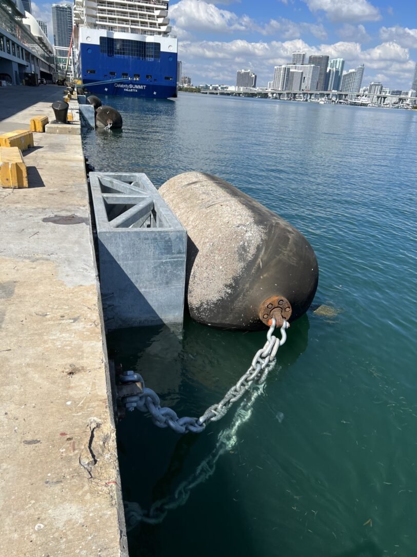 Foam-filled marine fenders installed along a berth